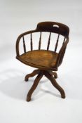 An early 20th century beech swivel office chair,