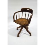 An early 20th century beech swivel office chair,