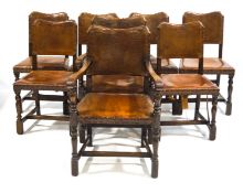 A set of eight oak dining chairs with leather backs and seats on turned legs