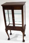 An early 20th century mahogany display cabinet, on stand, with two glass shelves,