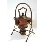 An Arts and Crafts style copper kettle on stand with wicker handle