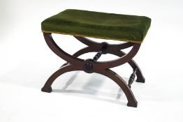 A 19th century mahogany X-frame stool, upholstered in green velour,