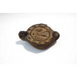 A Roman earthern ware oil lamp with moulded decoration,