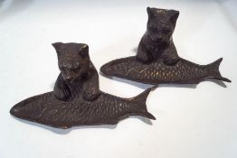 A pair of novelty patinated brass pen trays, modelled as cats holding fish,