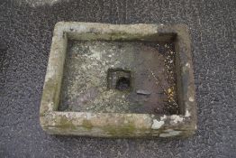 A square stone sink,