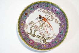 A Chinese Canton dish, painted with exotic birds among branches, 32.