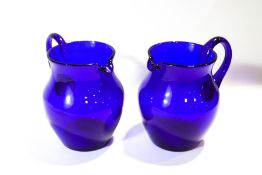 A pair of Bristol Blue jugs,