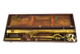 A 19th century brass astronomical telescope, with four lenses, housed in a mahogany case,