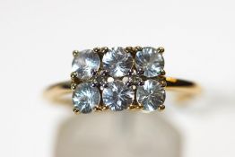 A 9ct gold six stone moissanite ring, finger size R1/2, 2.