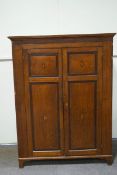 An early 19th Century oak two door cupboard with mahogany cross band,