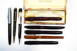 A collection of fountain and ballpoint pens including Parker, Burnham,