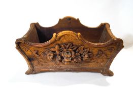 A Black Forest carved planter with carved flower and leaf mouldings,