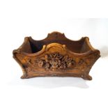 A Black Forest carved planter with carved flower and leaf mouldings,