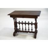 A Continental walnut side table with spindle panel stretcher linking turned supports,