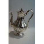 An Elkington & Co silver plated coffee pot, of segmented baluster form with embossed decoration,