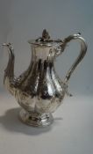 An Elkington & Co silver plated coffee pot, of segmented baluster form with embossed decoration,