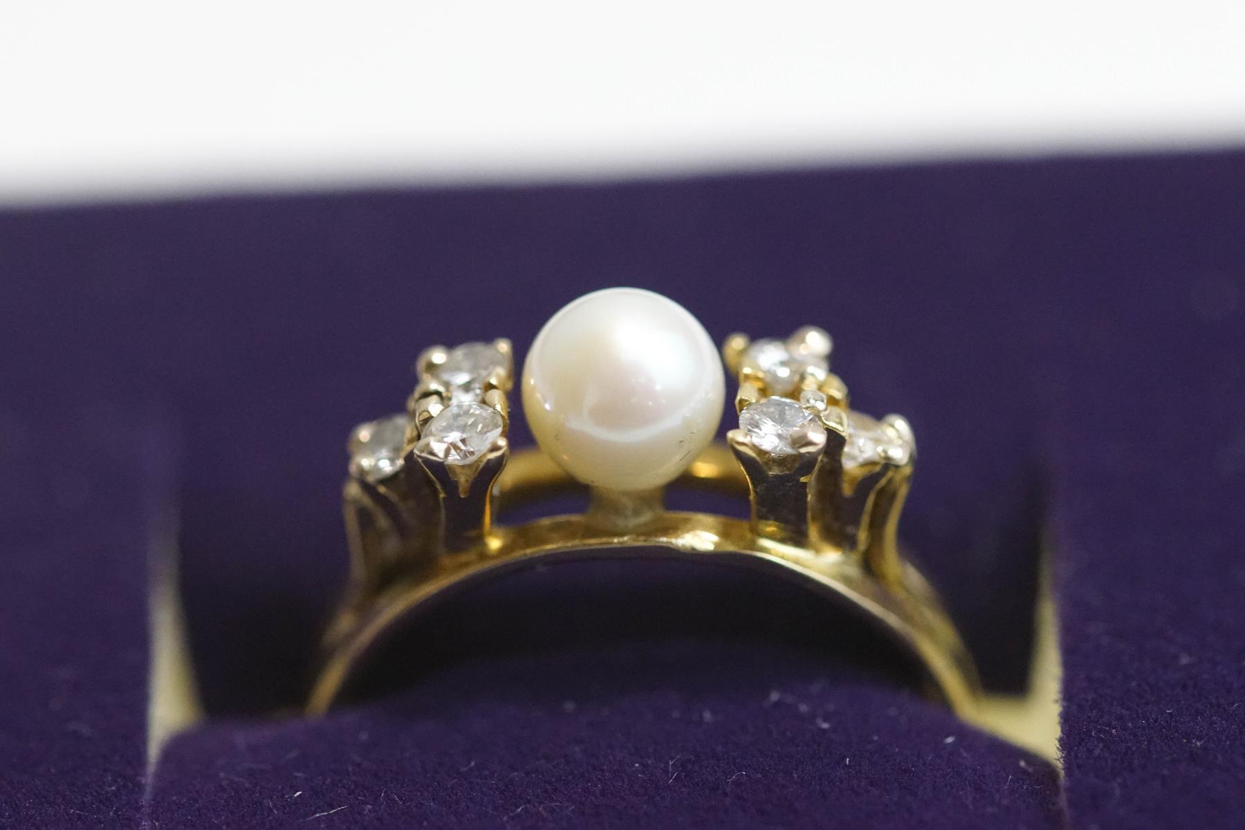 A cultured pearl and diamond ring, stamped '18K', the pearl, of approximately 5.