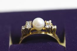 A cultured pearl and diamond ring, stamped '18K', the pearl, of approximately 5.