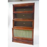 A four tier mahogany Globe Wernick bookcase with a drawer to the plinth and makers label to the