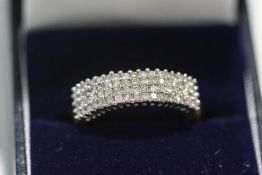A 9 carat gold sixty four diamond half hoop ring,