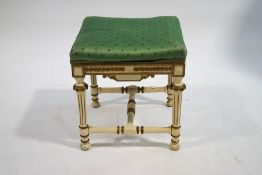 A square stool in Louis XVI style with painted and gilt legs,