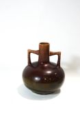 A Christopher Dresser style vase, with brown and green glazes,