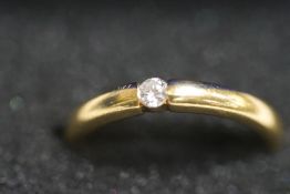 An 18 carat gold single stone diamond ring, the tension set brilliant cut of approximately 0.