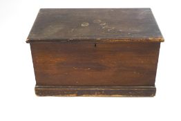 A pine blanket box with two handles and simulated wood grain finish,