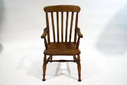 An ash and elm stickback elbow chair with turned legs and H stretchers