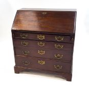 A George III mahogany bureau, the fall front enclosing a pigeon hole interior and drawers,