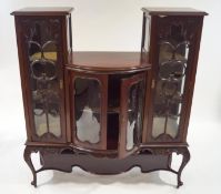 An Edwardian mahogany display cabinet with scroll glazing bars and the middle with bow fronted