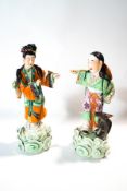 A pair of Chinese figures in traditional costume,