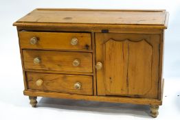 A painted dresser base with three drawers flanked by two cupboards, all with turned handles,