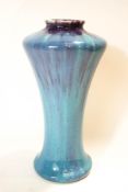 A Ruskin style pottery vase of flared wasted form, turquoise and purple streaked glaze,
