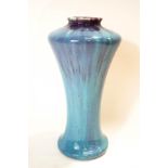 A Ruskin style pottery vase of flared wasted form, turquoise and purple streaked glaze,