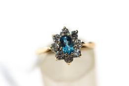 A 9 carat gold cubic zirconia and blue topaz cluster ring, finger size O1/2,