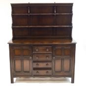 An Ercol darkwood dresser, with two tier raised rack above four drawers and two cupboards,