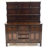 An Ercol darkwood dresser, with two tier raised rack above four drawers and two cupboards,