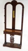A Victorian mahogany hall stand with turned coat finials flanking a mirror above, a lift up shelf,
