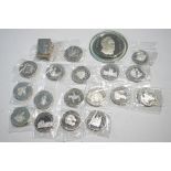 A quantity of commemorative silver coins and plaques,