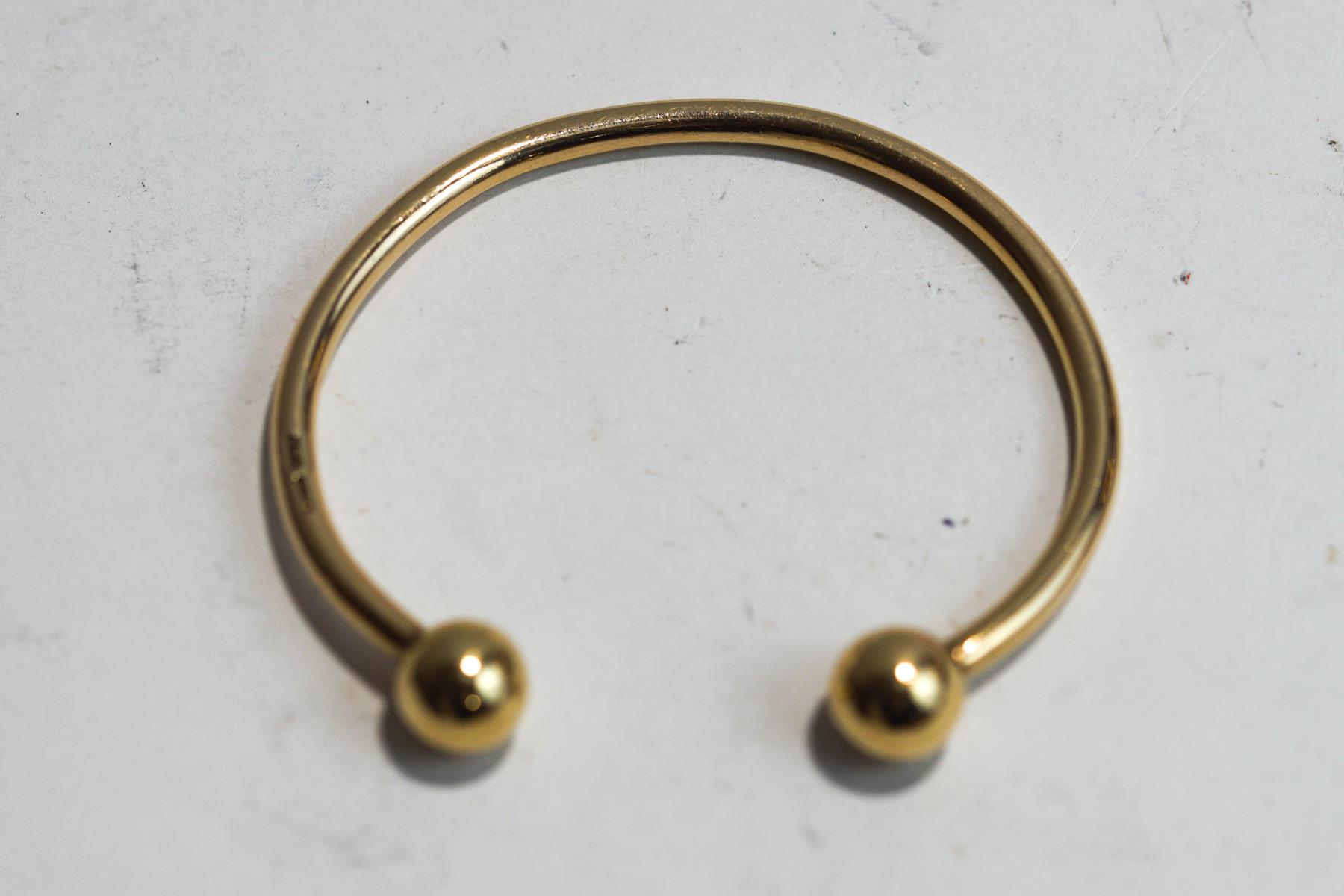 A 9 carat gold torque bangle, internal diameter currently 6.