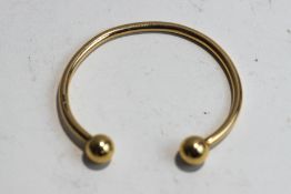 A 9 carat gold torque bangle, internal diameter currently 6.