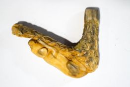 A deer horn walking stick handle, carved as a recumbent dog upon ivy covered ground, 10.