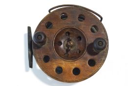 A wooden and brass 6" sea fishing reel