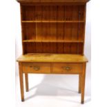 A pine dresser with raised back above two frieze drawers on square legs, 185cm high x 122.