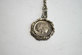 A silver watch chain, of graduated curb links, with a 1975 American One Dime coin attached,