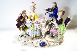 A large 19th century German porcelain figure group of two ladies and two gentlemen around a piano,