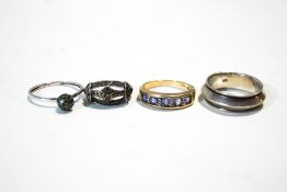 A collection of four silver rings