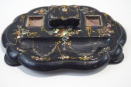 A Victorian papier mache inkstand with lidded compartment and mother of pearl inlay (missing ink