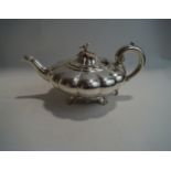 A Victorian silver teapot, by John James Keith, London 1838, of compressed melon shape,